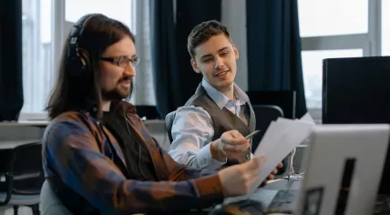 Two men working side-by-side on a project in 2021