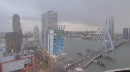 Trams, cars, and bicyclists try to navigate Rotterdam's rush hour as Storm Benjamin makes its way across the Netherlands. 23 October 2025