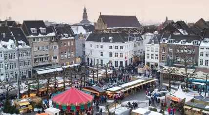 Beautiful view on the city of Maastricht, with a Christmas market on the square on a snowy winter's day