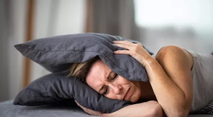 A woman is experiencing severe ear pain