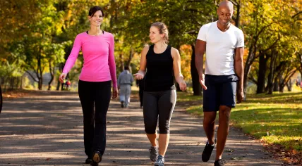 People exercise in a park on an autumn day
