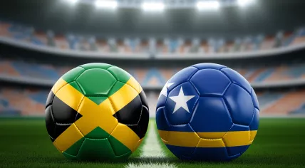 The flag of Jamaica on a football alongside the flag of Curaçao on a football inside a stadium. Rendering