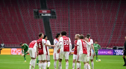 Ajax players celebrate the 1-0 goal during the remainder of the Dutch Eredivisie match between AFC Ajax and FC Groningen, played without spectators, at the Johan Cruijff ArenA on December 2, 2025, in Amsterdam, Netherlands. The match was abandoned after fans set off fireworks twice.