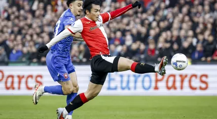 Stav Lemkin of FC Twente and Ayase Ueda of Feyenoord during the Dutch Eredivisie match between Feyenoord and FC Twente at Feyenoord Stadion De Kuip on December 21, 2025, in Rotterdam, the Netherlands.