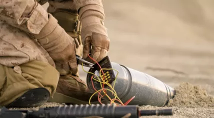 Close-up shot of soldier defusing a bomb