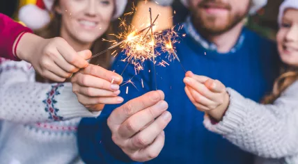 Family poses with sparklers on New Year’s Day.
