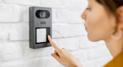 Woman rings a doorbell 