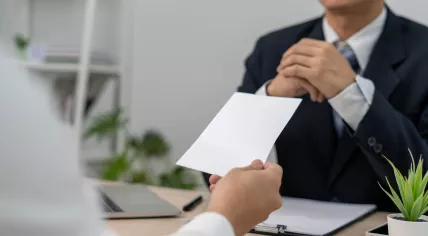 Worker hands in a resignation letter