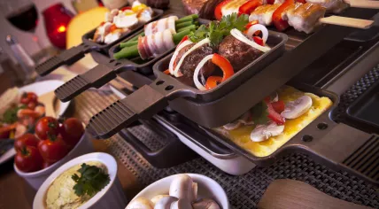 A group of people going Dutch, and using their gourmet set, where everyone cooks their own food at the table. 2015