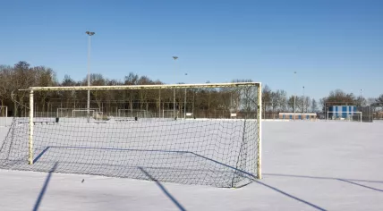 Snow-covered amateur football field in the Netherlands