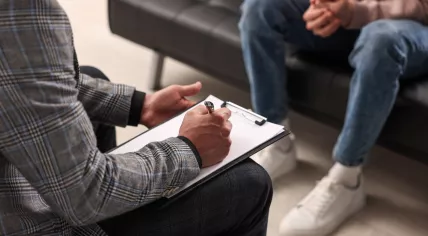 Professional psychotherapist working with patient in office