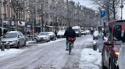 A biker riding slow and steady on the icy Javastraat in Amsterdam-Oost. 5 Jan. 2026