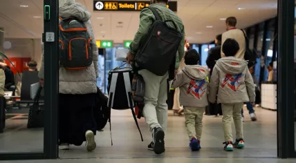 A Syrian family walks through Schiphol Airport before departing the Netherlands.