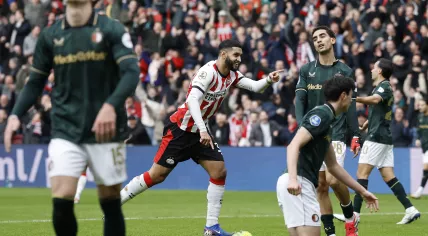 Oussama Targhalline of Feyenoord looks dejected as Ismael Saibari of PSV Eindhoven celebrates the 3–0 during the Dutch Eredivisie match between PSV and Feyenoord at the Philips Stadion on February 1, 2026, in Eindhoven, the Netherlands.