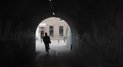 A woman rides through a tunnel