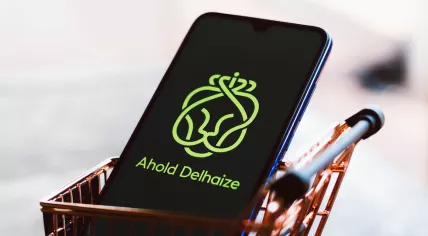 The Ahold Delhaize logo displayed on a smartphone along with a shopping cart, September 2, 2021.