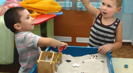 Children playing at a sand table
