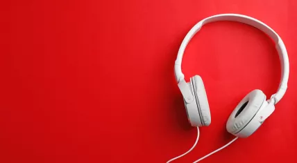 White headphones on a red brackground