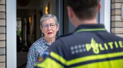 An undated photo of a Dutch police officer speaking to an elderly woman.