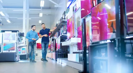 A man is choosing a TV to buy.