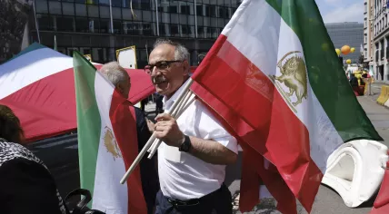 A man holds Iranian flags