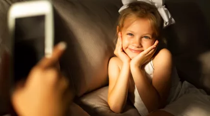 Taking a picture of a little girl.