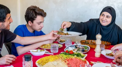 Muslim family eating together