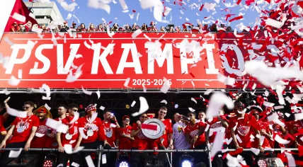 Players of PSV with the championship trophy during the team’s celebration at Stadhuisplein. The club has won the Eredivisie title for the third consecutive time, marking their 27th national championship.
