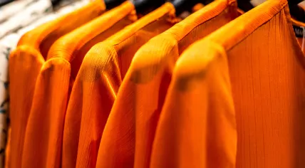 Orange tops at a clothing store.