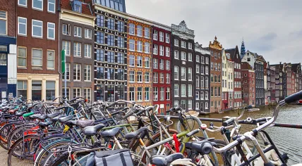 Bikes parked on the Nieuwe Brug in Amsterdam along Prins Hendrikkade, near the Damrak. Feb. 2020