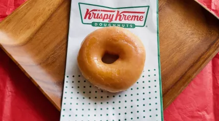 A Krispy Kreme Original Glazed doughnut with Krispy Kreme logo