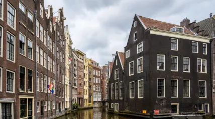 The rear facades of buildings on the Zeedijk at the intersection of to Amsterdam city center canals, Oudezijds Voorburgwal and Oudezijds Achterburgwal. July 2025
