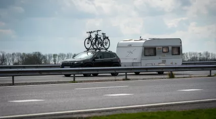 Holidaymaker: A car with bikes on the roof pulls a caravan on a Dutch highway