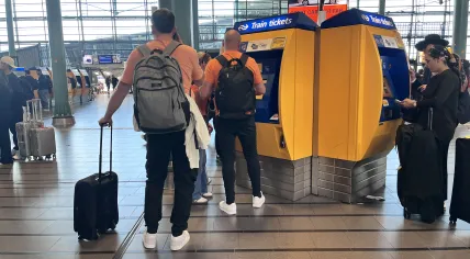 Tourists buying train tickets on King's Day at the Schiphol Airport rail station. 27 April 2026