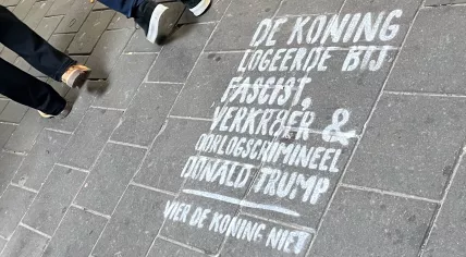 A protest message outside the Muiderpoort Station in Amsterdam criticizing King Willem-Alexander for his State visit with U.S. President Donald Trump. 27 April 2026