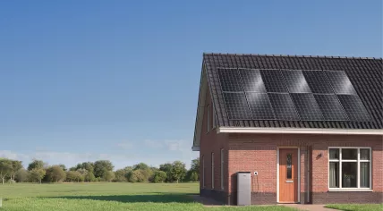 The SolarVault 3 home energy storage solution installed alongside a home with solar panels placed on the roof. April 2026