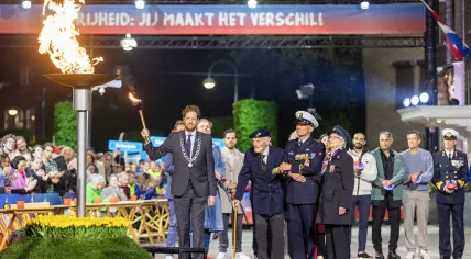 British veteran Robbie Hall, 103, and Dutch veteran Johan Geneuglijk, 105, light the liberation flame alongside Mayor Floor Vermeulen during the liberation fire ceremony in Wageningen, Netherlands. May 4, 2026