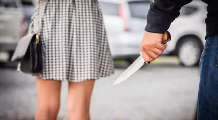 A boy follows a girl with a knife.