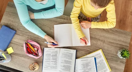 Mother and daughter doing schoolwork together.