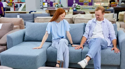 A couple is choosing a couch.