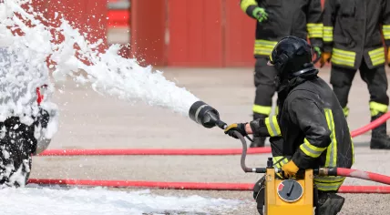Firefighter uses firefighting foam.