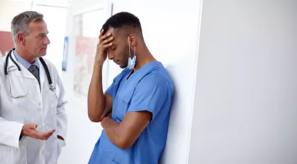 Two medical workers are having a difficult conversation.