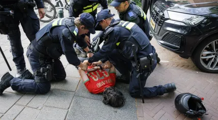 Police detain a person as riot police and a water cannon are deployed in a residential district following Morocco’s World Cup victory over the Netherlands. June 30, 2026.