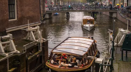 People on a canal boat tour in Amsterdam in 2022.