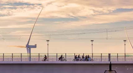 Group of schoolchildren cycling on a bridge in Nijmegen. 12 Nov. 2025