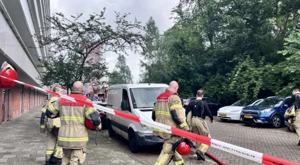 Firefighters by an apartment block in Amsterdam Nieuw-West hours after a severe explosion, June 12, 2026.