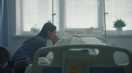Mother sitting with a sick child in a hospital