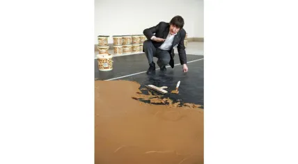 Wim T. Schippers creating his peanut butter floor artwork