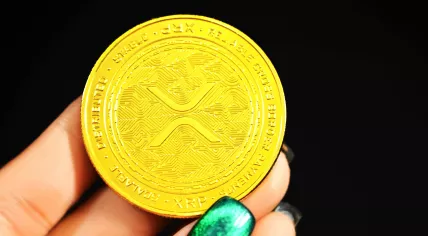 A physical coin meant to represent an XRP (Ripple) token. 2021