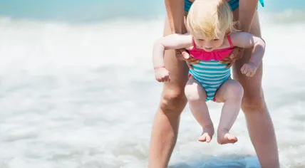 Playing with a baby on a beach.